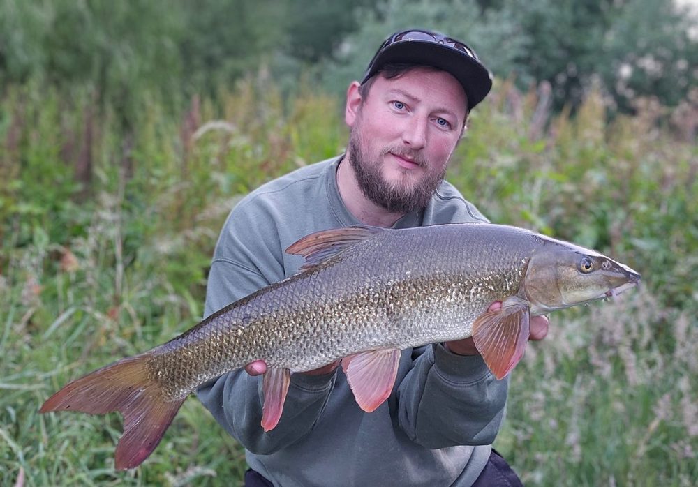 Robbie Cunnington holding a 6lb barbel at Elton Fishery