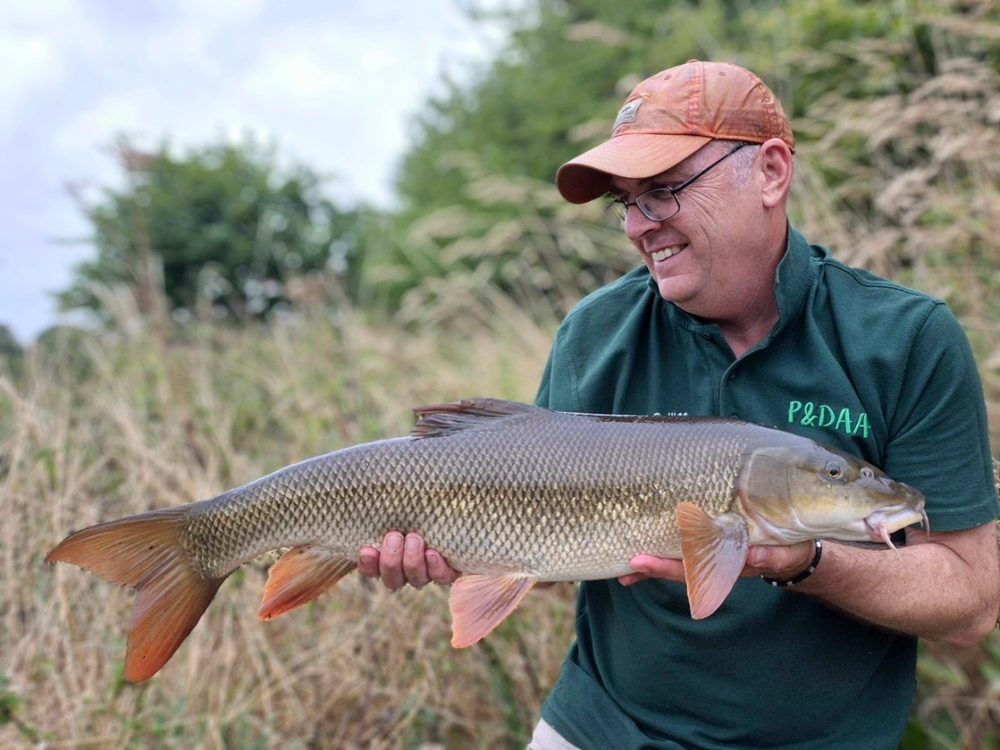 Martin Barnatt holding a chub at Elton Fishery