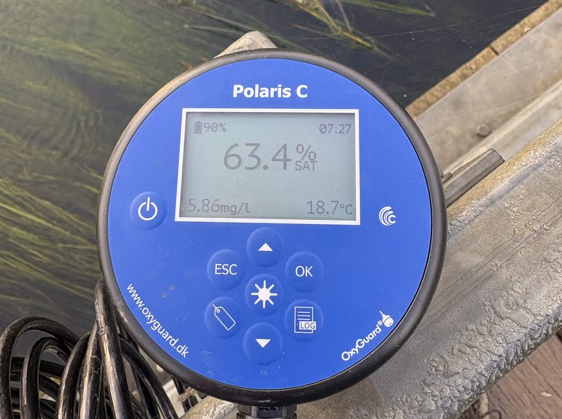 A dissolved oxygen meter reading 5.86mg per litre at 18.7 degrees on the river bank at 7.27am